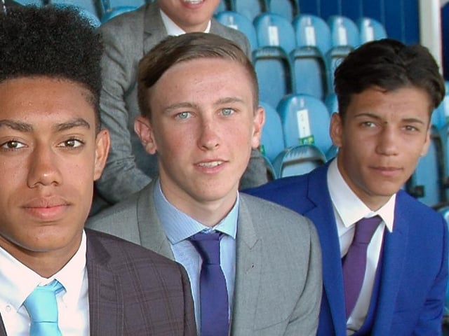 The midfielder poses with his team-mates after penning his apprenticeship in 2014.