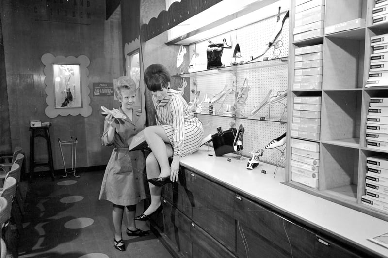 A woman tries on a new pair of heels at the shoe department of the Leith Provident (May 1966).
