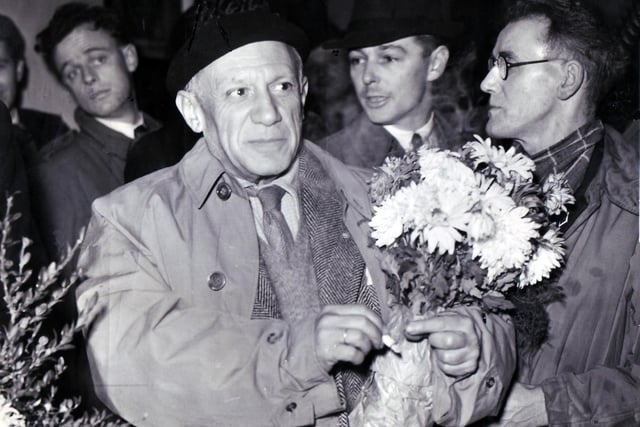 Pablo Picasso, left with Tommy Jones (right - in glasses) arrival at Sheffield L.M.S. Station for the "Peace" Congress at the City Hall.  1950