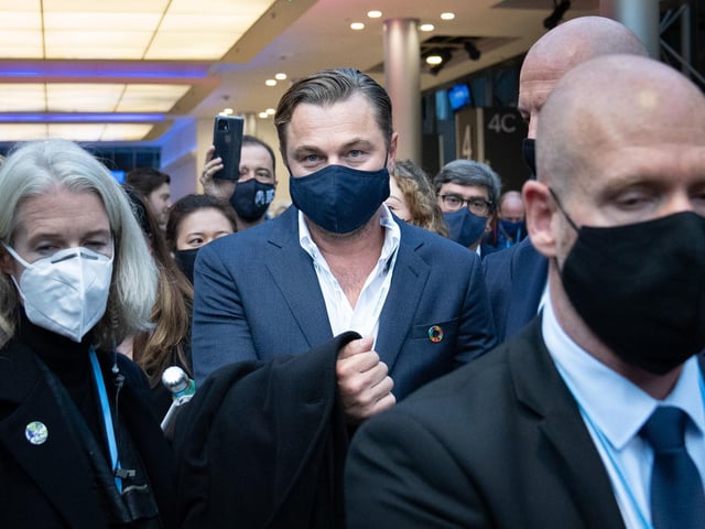 Leonardo DiCaprio was pictured walking through the exhibition hall with an entourage.