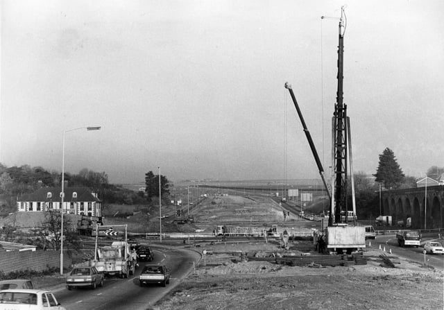 Fareham: A view of the work in progress on the Delme Roundabout Flyover, showing the giant pile-driver in position and the route that the road will take in November 1983. The News PP987