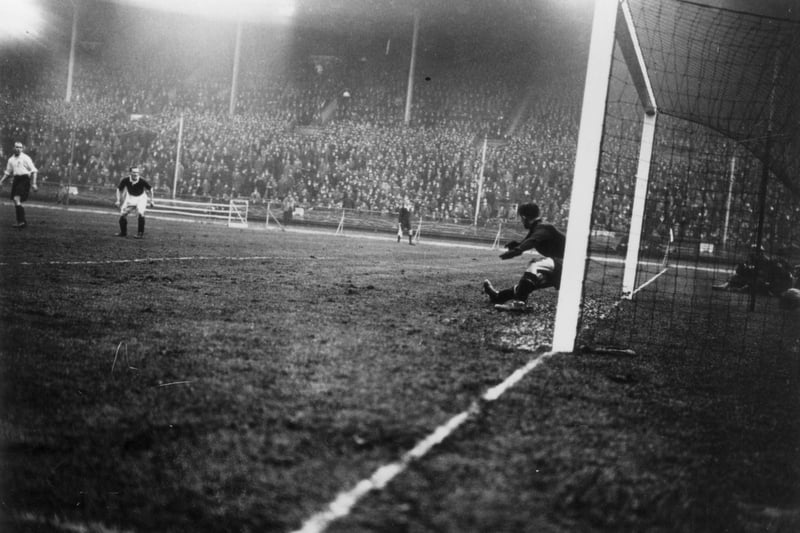 England goalkeeper Ted Hufton is beaten by a shot from Scotland's Alex Jackson during the Wembley Wizards match