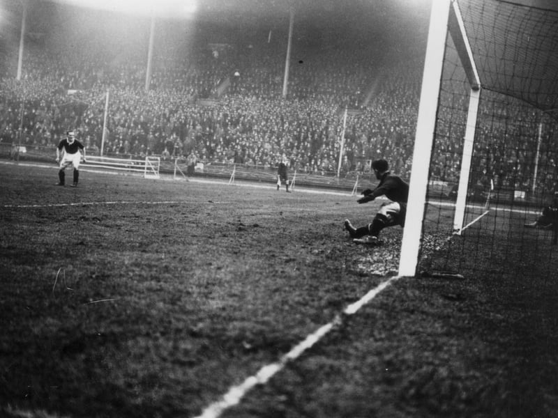 England goalkeeper Ted Hufton is beaten by a shot from Scotland's Alex Jackson during the Wembley Wizards match