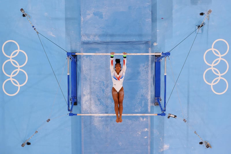 Melanie de Jesus dos Santos of Team France competes on the uneven bars during the Women's Team Final on day four