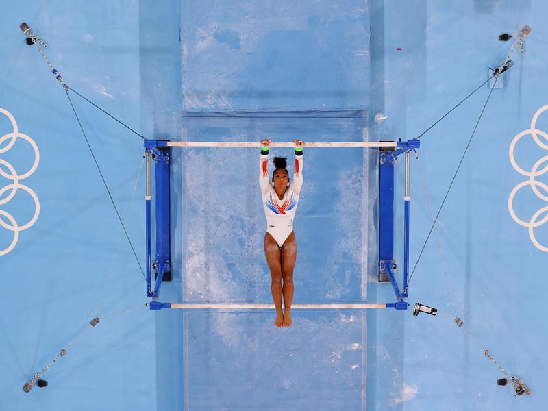Melanie de Jesus dos Santos of Team France competes on the uneven bars during the Women's Team Final on day four