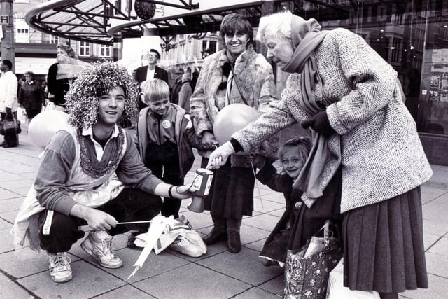 The University Rag Day Parade 1990 - a student in fancy dress collecting money in High Street, Sheffield