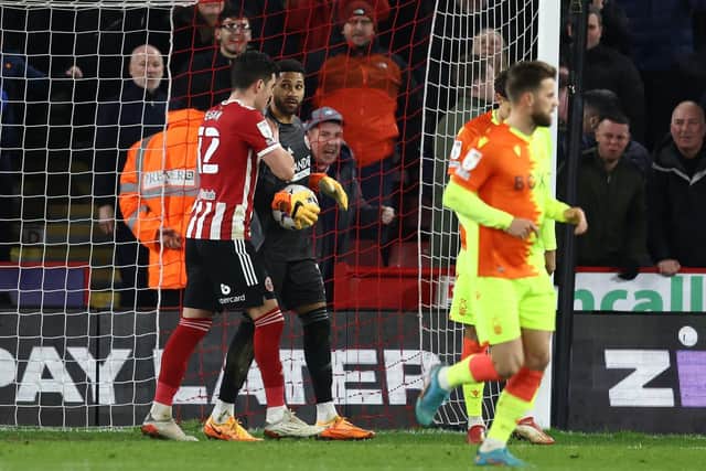 Sheffield United's John Egan congratulates Wes Foderingham following his penalty save from Breenan Johnson of Nottingham Forest. Picture: Darren Staples / Sportimage