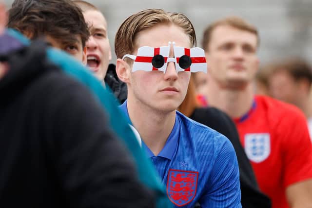An England supporter wears St George's cross glasses while watching the UEFA Euro 2020 football match between England and Germany at the fan zone in central London (AFP/Getty Images)