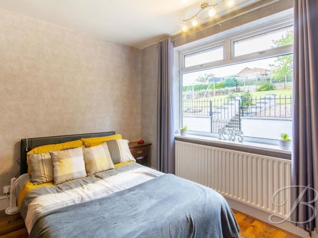 The second bedroom is also a good size. It features a laminated floor, central-heating radiator and window to the back.
