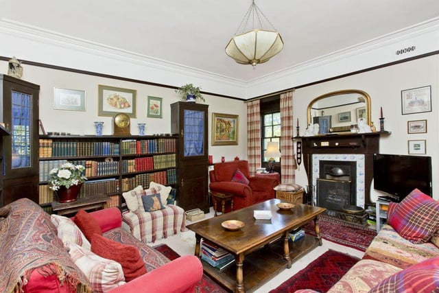 A large family room accommodates bespoke library shelves and boasts a triple-windowed turret.
