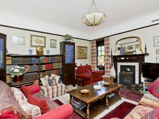 A large family room accommodates bespoke library shelves and boasts a triple-windowed turret.