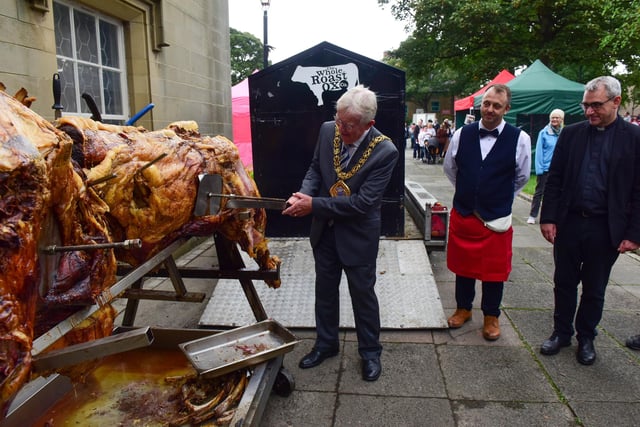 The Mayor of Sunderland Coun. Harry Trueman cuts the first slice from the roast ox at the Houghton Feast parade on Saturday.