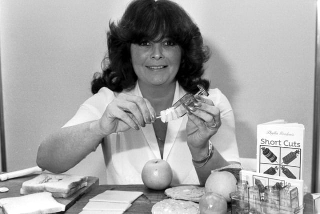 Elaine Hayton demonstrates a device for making cocktail nibbles on sticks, one of the gadgets on sale at the Ideal Home Exhibition in Edinburgh, April 1983