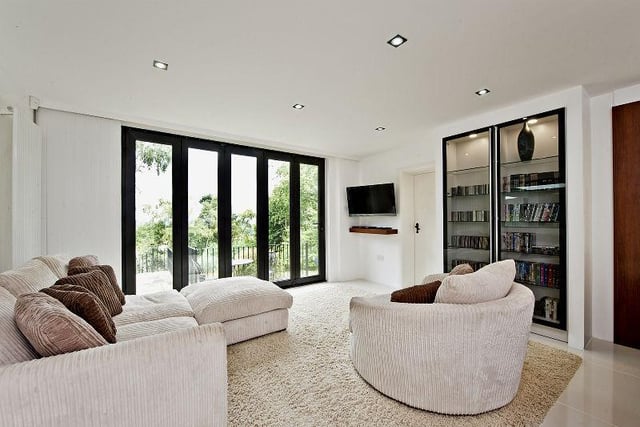 The kitchen extends into a comfy sitting area complete with folding glass doors that open out onto the rear garden.