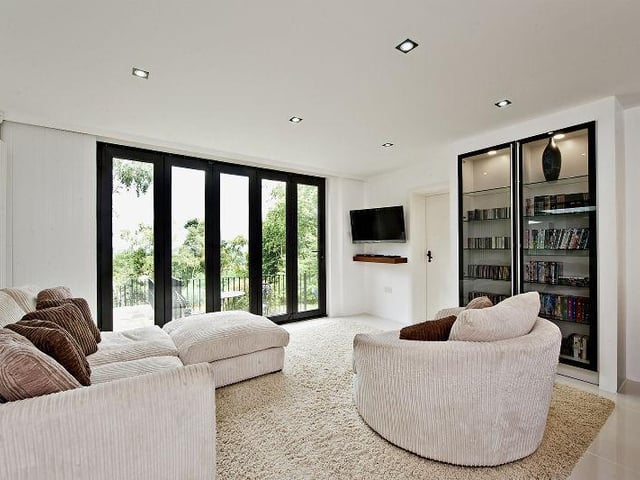 The kitchen extends into a comfy sitting area complete with folding glass doors that open out onto the rear garden.