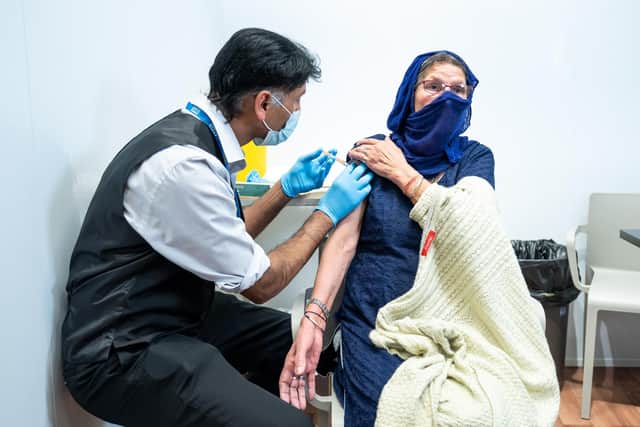 Handout photo issued by Asda of Harbans Kaur, 78, from Smethwick, being vaccinated against coronavirus by a qualified Asda pharmacy colleague at an Asda in West Bromwich
