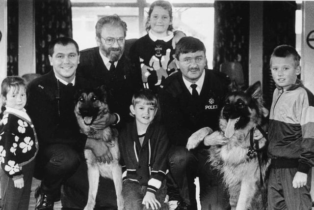 Police dog handlers Ian McDonald and Bob Dignen are pictured with school liaison officer PC Owen Clarke and Rift House Primary School pupils in 1991. Are you in the picture?