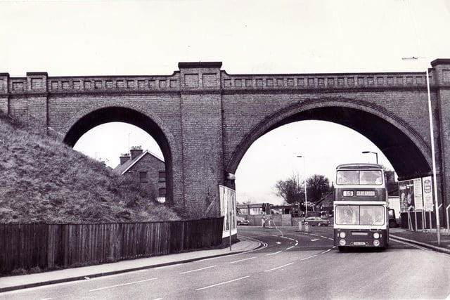 A bus makes its way under the viaduct over Derby Road at Horns Bridge. in 1974