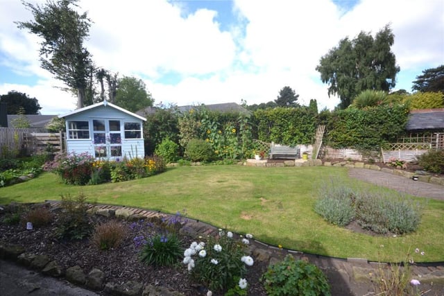 To the rear there is a pretty garden mainly laid to lawn with an abundance of colourful shrubs and plants. There is also a patio area ideal for sitting out in warmer weather and a summer house.