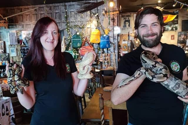 Debbie Voice and Declan Tormey, of Scales and Tails Sheffield, with three of their snakes during an event at The Steel Cauldron cafe