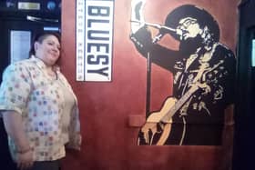 Kath Thorpe, co-owner of The Queen pub in Doncaster, with the new mural of Steve Keeton, who died after suffering from Covid-19