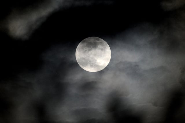 Clouds begin to obscures Earth's satellite during the first supermoon since early March.