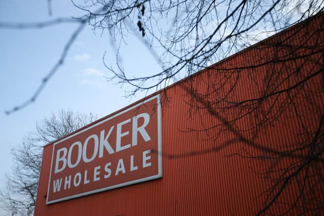The signage on a branch of Booker wholesale food store (Photo credit should read DANIEL LEAL-OLIVAS/AFP via Getty Images)