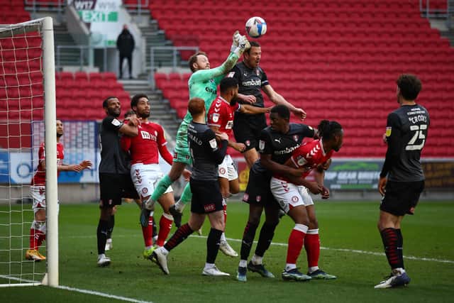 Viktor Johansson of Rotherham United punches the ball clear under pressure during the Sky Bet Championship match between Bristol City and Rotherham United.