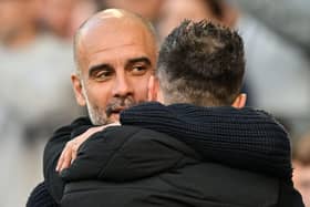 Manchester City's Spanish manager Pep Guardiola (L) hugs Brighton's Italian head coach Roberto De Zerbi at the start of the English Premier League football match between Brighton and Hove Albion and Manchester City at the American Express Community Stadium in Brighton, southern England on May 24, 2023. (Photo by Glyn KIRK / AFP) / RESTRICTED TO EDITORIAL USE. No use with unauthorized audio, video, data, fixture lists, club/league logos or 'live' services. Online in-match use limited to 120 images. An additional 40 images may be used in extra time. No video emulation. Social media in-match use limited to 120 images. An additional 40 images may be used in extra time. No use in betting publications, games or single club/league/player publications. /  (Photo by GLYN KIRK/AFP via Getty Images)