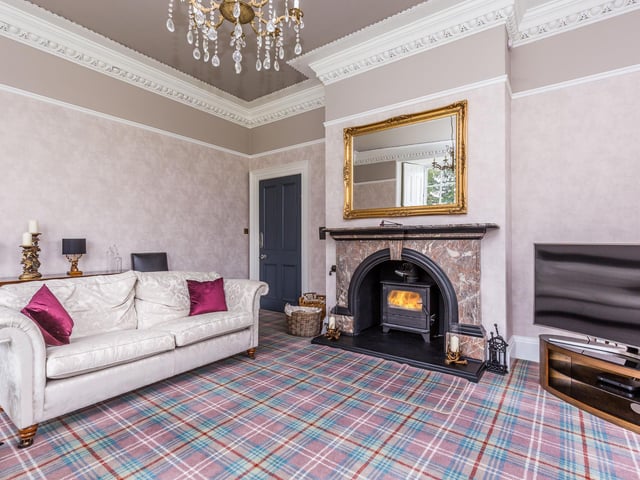 A large reception room benefitting from open views over the gardens and beyond. Ornate coving and skirting, original shutters to the windows. Feature fireplace with marble fireplace and surround and inset wood burning stove.