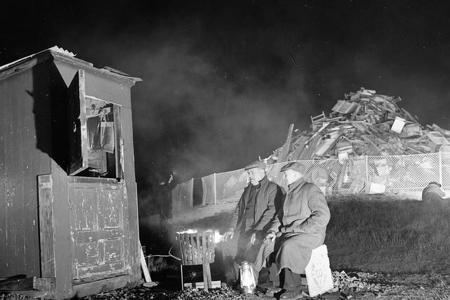 Two nightwatchman guard the bonfire that was to be lit to celebrate the birth of Prince Edward at Calton Hill on March 10, 1964.