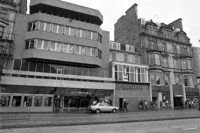 John Menzies the bookstore and newsagent, next to a boarded-up shop in Princes Street Edinburgh, May 1980.