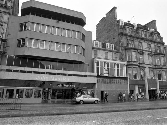 John Menzies the bookstore and newsagent, next to a boarded-up shop in Princes Street Edinburgh, May 1980.