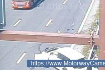 Emergency services have been sent to deal with a crash on the M1 near Sheffield, say police. PIcture shows the scene, with a white car appearing to have crashed