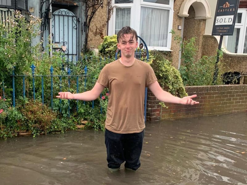 Residents of Salisbury Road in Cosham are calling for urgent action after flooding has hit their street. Jonah Ford stands in the flood. Picture: Lucy Heard