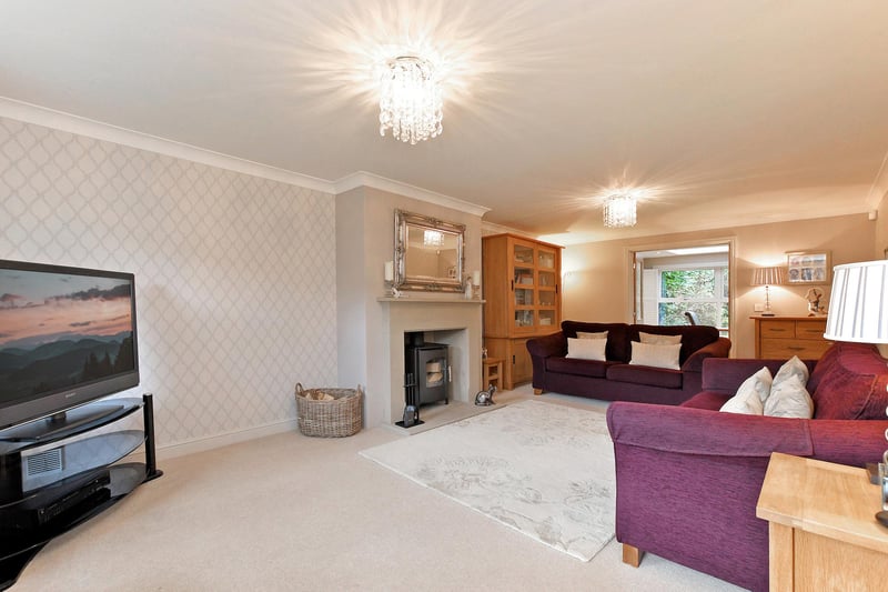A generously proportioned reception room with front facing windows, coved ceiling, flush light points, central heating radiators, telephone point and TV/aerial points. The focal point of the room is the log burning stove with a sandstone mantel, surround and hearth.