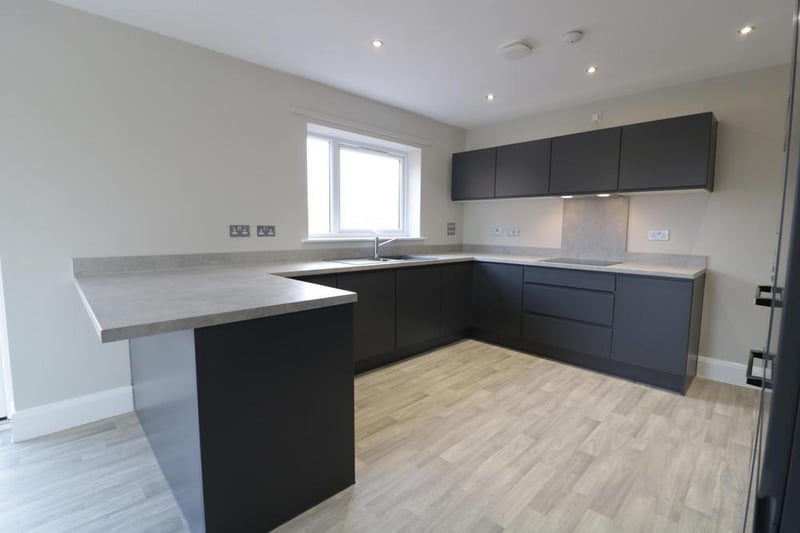 This three storey home has a large kitchen dining area with a separate utility room. It also boasts a large living room with five bedrooms and four bath/shower rooms.