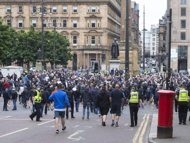 Missiles could be seen flying between the two groups as police - with their batons drawn - formed a line across the street.