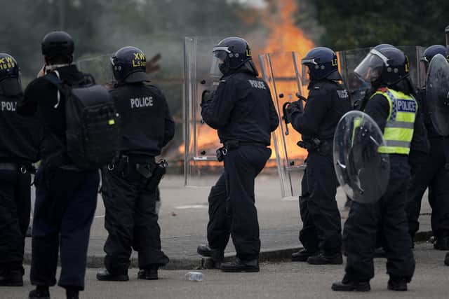 Riot police outside the Holiday Inn Express Hotel in Rotherham on August 4, 2024.