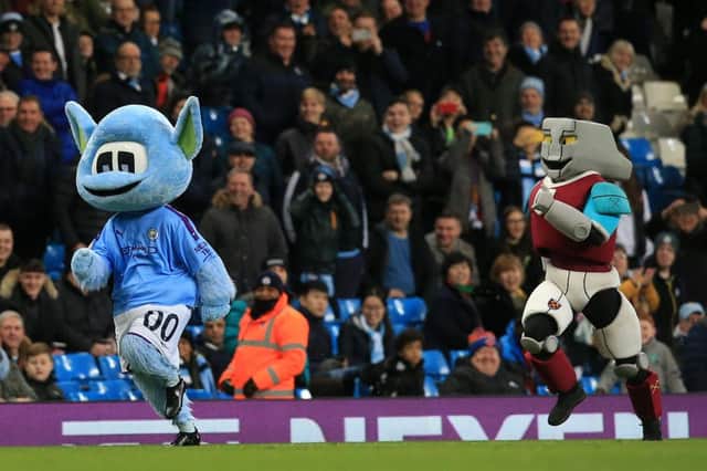 Man City mascot Moonchester beats West Ham mascot Hammerhead in a foot race.  (Photo by LINDSEY PARNABY/AFP via Getty Images)