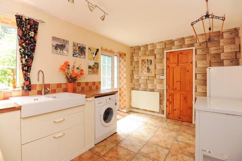 The utility room boasts twin Belfast sinks and space for a washing machine.