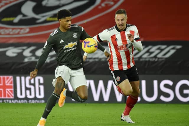 SHEFFIELD, ENGLAND - DECEMBER 17: Marcus Rashford of Manchester United is challenged by Phil Jagielka of Sheffield United during the Premier League match between Sheffield United and Manchester United at Bramall Lane   (Photo by Rui Vieira - Pool/Getty Images)
