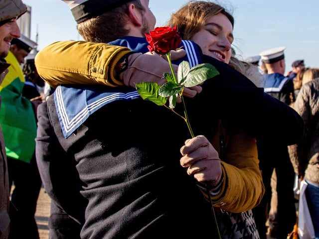 Crew members stepping off HMS Diamond embracing their loved ones. Picture: Habibur Rahman