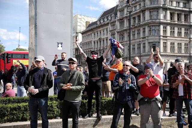 Following a social media post by the far-right activist known as Tommy Robinson, members of far-right linked groups have gathered around statues in London.  (Photo by Dan Kitwood/Getty Images)