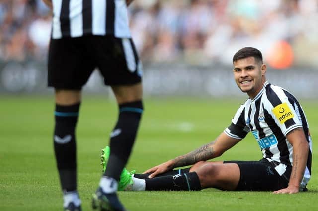 Newcastle United's Brazilian midfielder Bruno Guimaraes (R) reacts after being fouled during the English Premier League football match between Newcastle United and AFC Bournemouth at St James' Park in Newcastle-upon-Tyne, north east England on September 17, 2022. (Photo by LINDSEY PARNABY/AFP via Getty Images)