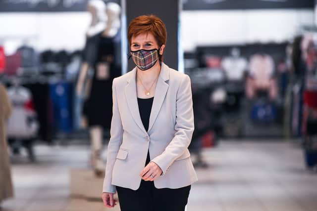 Nicola Sturgeon decided to extend the legal requirement to wear Covid face masks in certain settings by two weeks (Picture: Jeff J Mitchell/WPA pool/Getty Images)