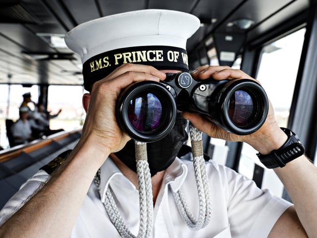 Joshua Penfield, an able seaman specialist looks out over Portsmouth.
HMS Prince of Wales has returned to sea for a spell of testing and trialling, following an extended period alongside conducting maintenance and installing new, cutting-edge capabilities. HMS Prince of Wales is the most capable and powerful surface warship ever built for the Royal Navy and will be a future flagship for the next 50 years.
The 73,000 tonnes ship and her crew will then proceed to the South West cost to conduct a period of Basic Operational Sea Training to test ship and crew capabilities. The intense operational training enables - Availability, Sustainability and Lethality of HMS Prince of Wales. The Ship’s Company are crucial to the successful operation of the ship and training and trials are essential in ensuring that HMS Prince of Wales is the cornerstone of a Modern, Ready and Global Navy for a Global Britain