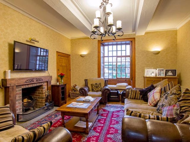 The snug has a fireplace and a window seat.