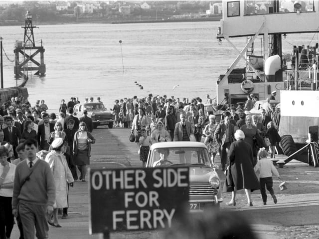 People and cars turned out en masse to see the opening of the Forth Road Bridge in September 1964 - cars and crowds coming off the ferry at South Queensferry.