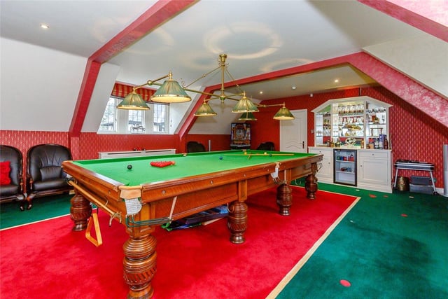The large games room is accessed via a spiral staircase and houses a full size snooker table, bar area and bespoke handmade carpet.